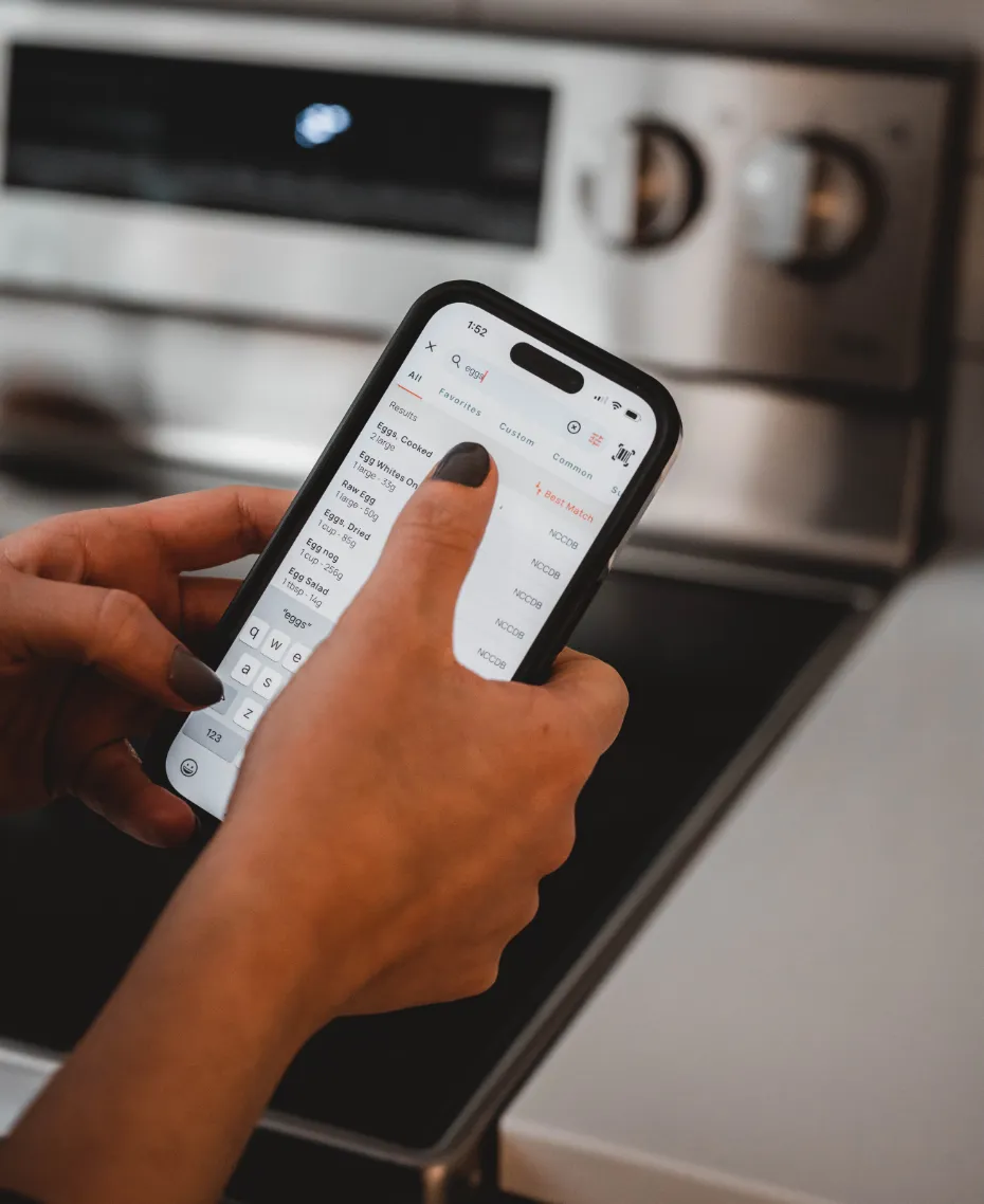A person logging food on the Cronometer app on their smartphone.