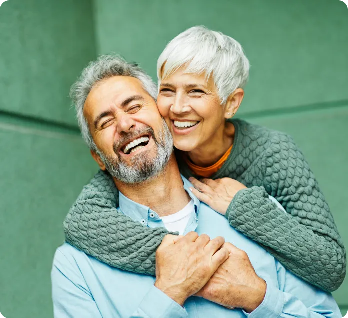 A man and woman hugging each other.