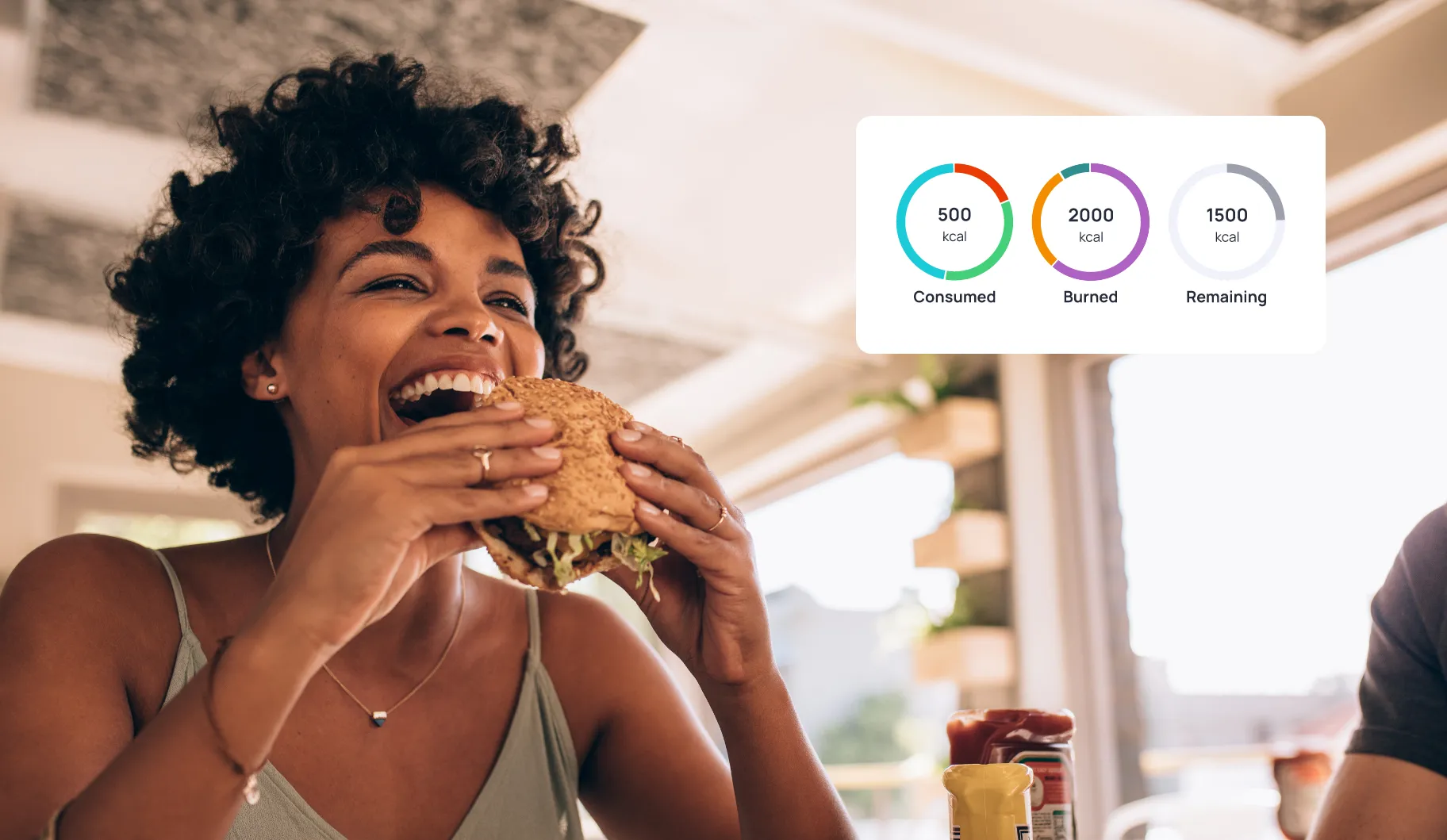 A woman eating a sandwich with nutritional information from Cronometer on it.