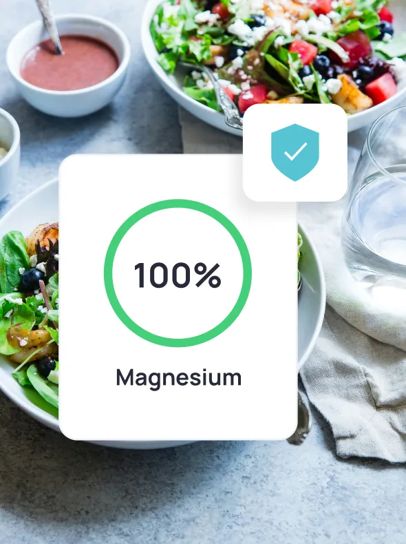 A close up of a salad with a green label that says 100% Magnesium from the Cronometer app.