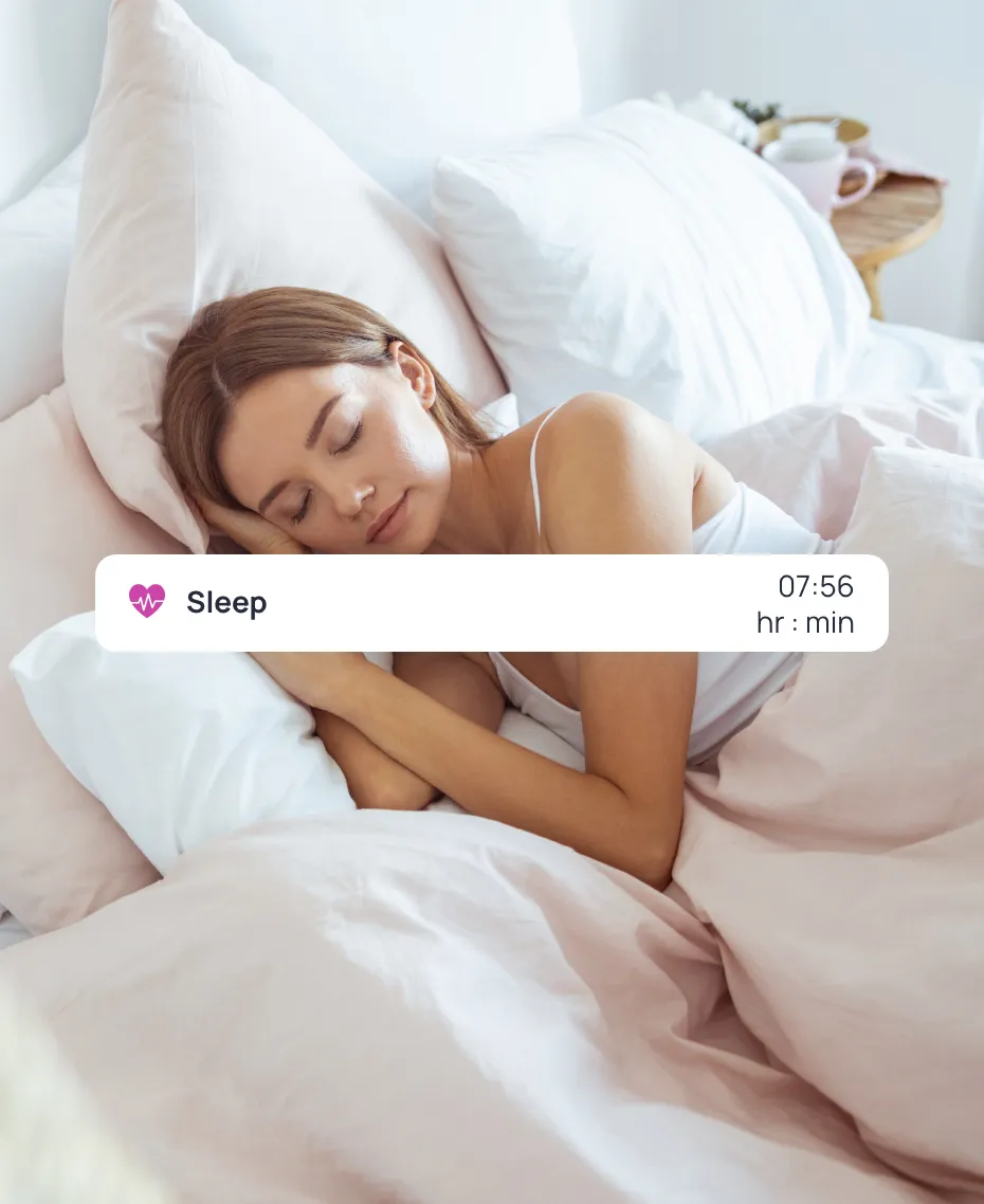 A woman sleeping on a bed with a sleep entry from Cronometer