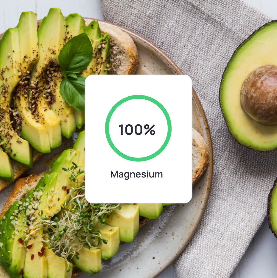 A close up of a plate of food with a green leafy vegetable a nutrient value from Cronometer on it.