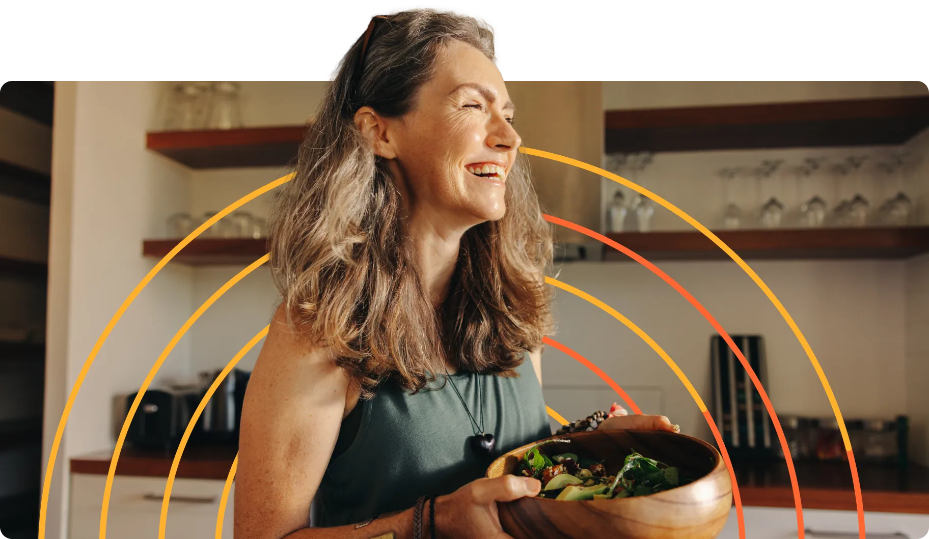 A woman holding a bowl of food with a smile on her face.