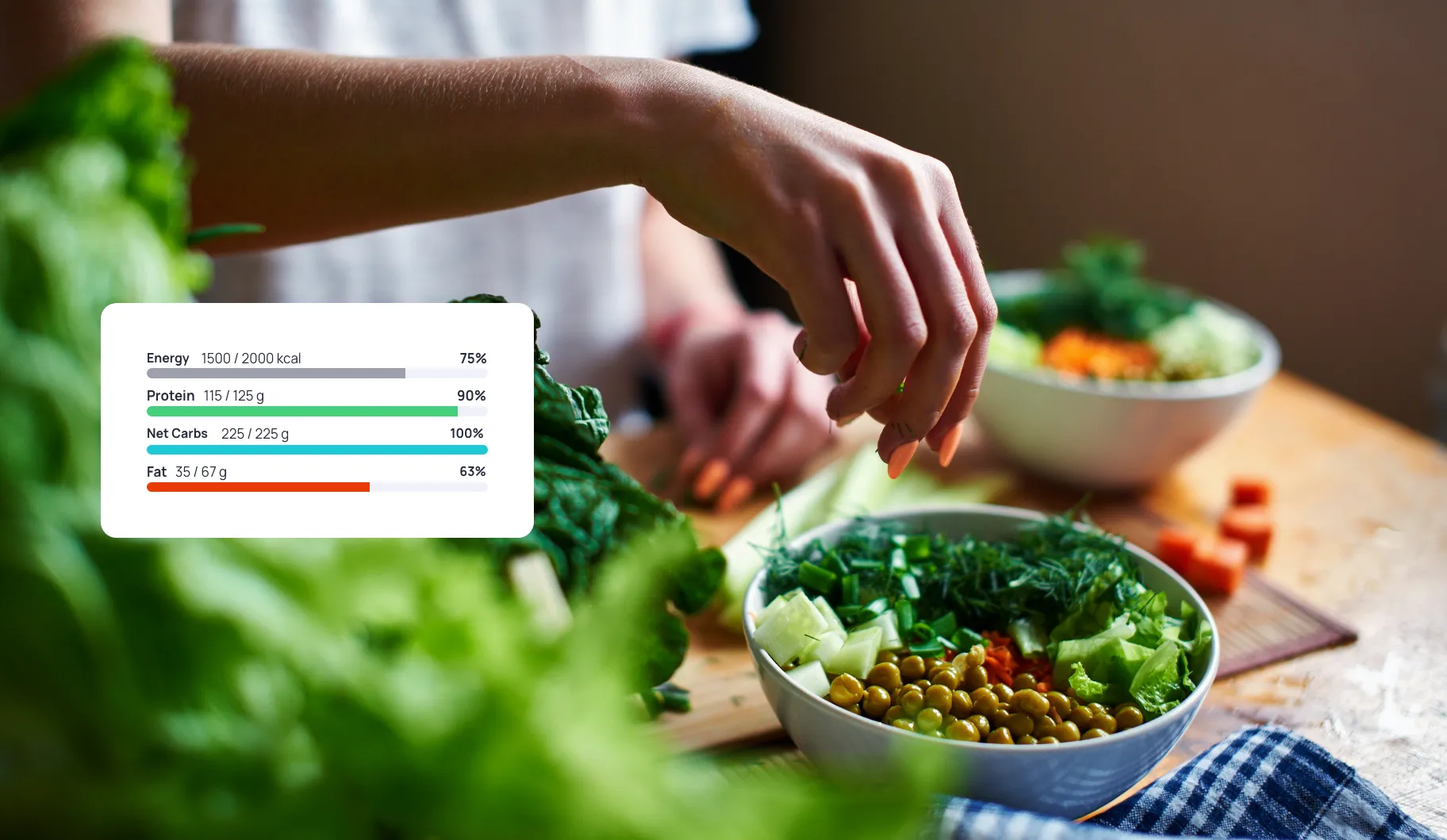 A person is cutting up vegetables on a cutting board with a nutrient chart from Cronometer on it.