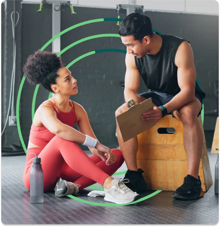 A man and woman sitting on the floor talking.
