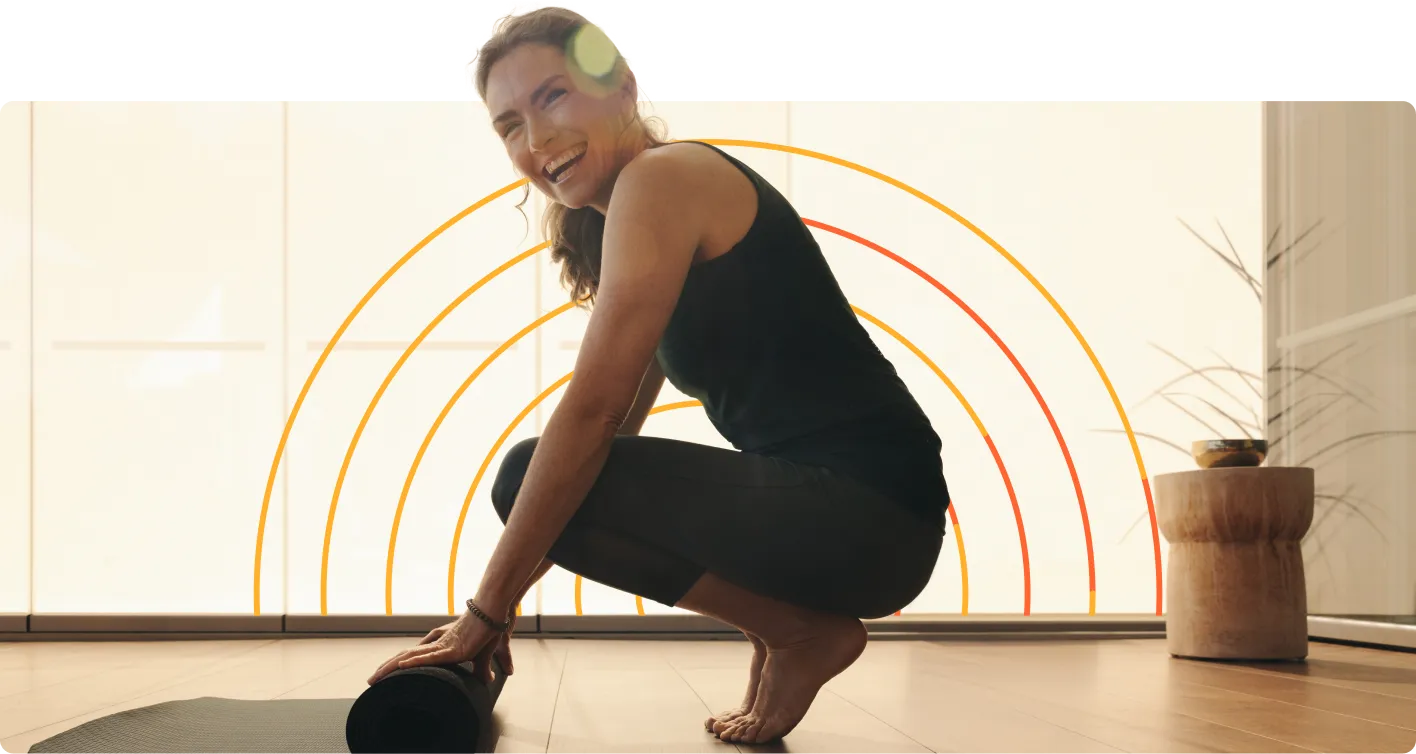 A woman is doing a yoga pose in front of a rainbow.