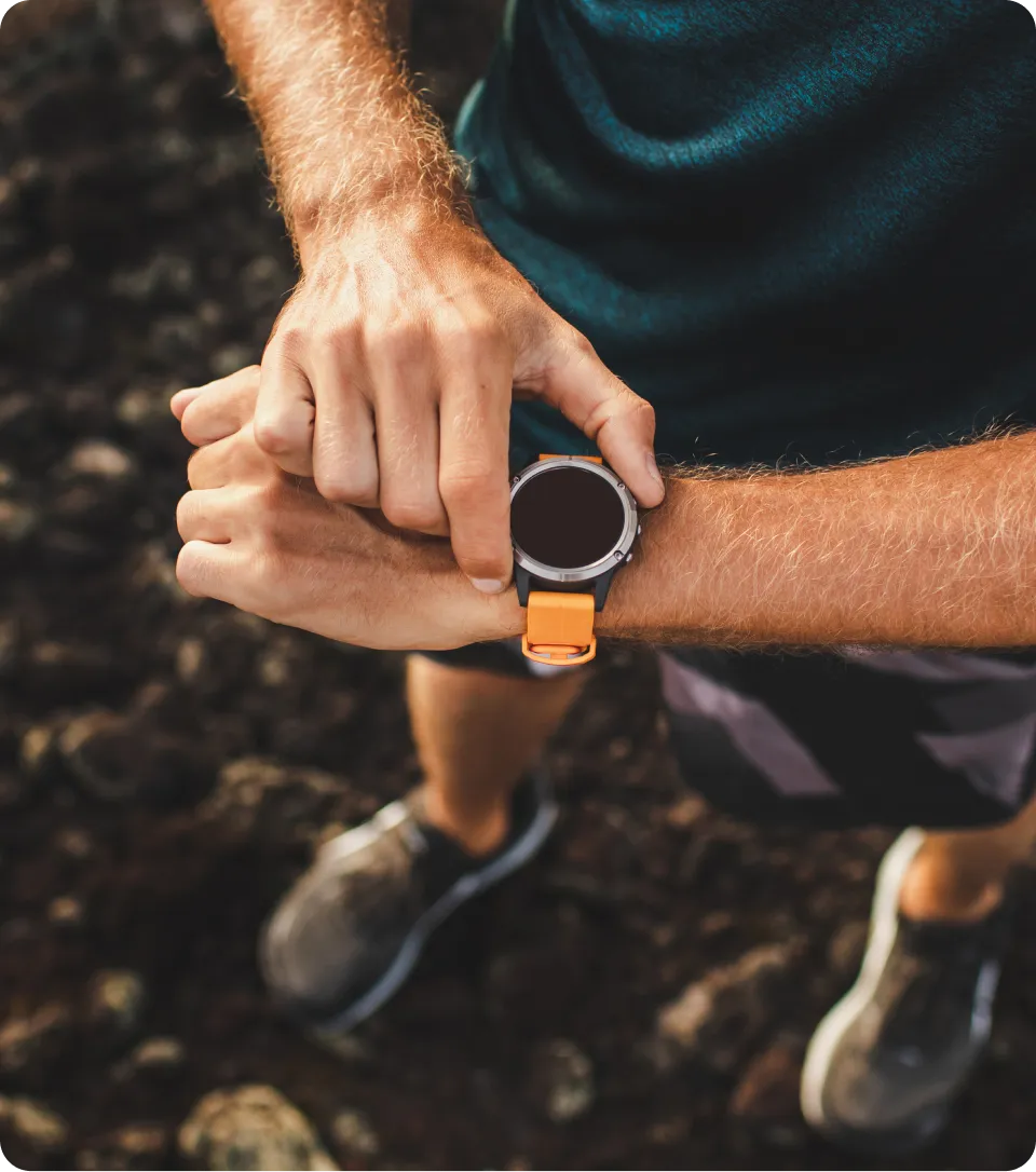 A man wearing a Garmin watch and shorts.