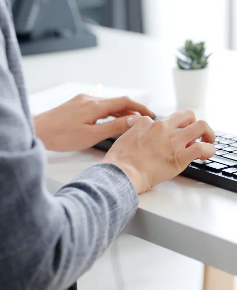 A person typing on a keyboard.